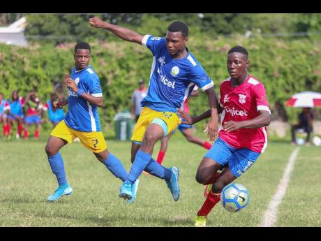 Camperdown’s Shaqueil Bradford (right) is hounded by Hydel’s Michael Thompson (centre) and Shaquise Batice during their ISSA/Digicel Manning Cup encounter at Alpha Boys’ Home on Friday, September 13.