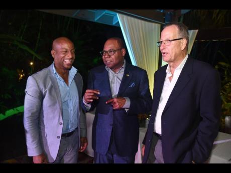 Minister of Tourism Edmund Bartlett (centre) shares a light moment ahead of the start of the 15th anniversary celebration of Sunset at the Palms Resort, in Negril, with managing director of the hotel, Ian Kerr (right), and President of the Jamaica Hotel and Tourist Association, Omar Robinson. 