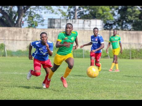 St Jago High School’s Jahvel Granville (second left) turns away from Holy Trinity’s High School’s Shemari Glade (left) during their ISSA/Digicel Manning Cup encounter at the Spanish Town Prison Oval on Monday, October 7, 2019. 