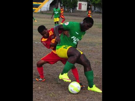 Cornwall College’s Leonardo Murray (left) tackles Green Pond High’s Peter Campbell in a daCosta Cup schoolboy football match in an undated Gleaner photograph. 