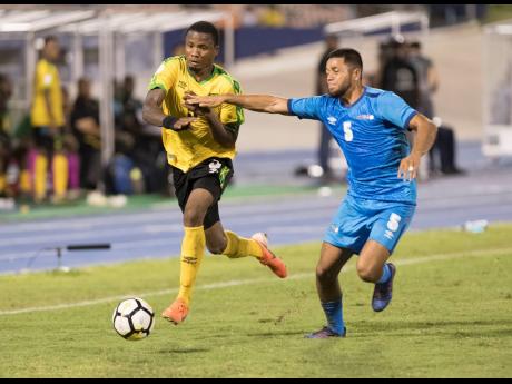 Jamaica’s Alvas Powell (left) on the offensive against Aruba’s Noah Harms in their Concacaf Nations League B game at the National Stadium in Kingston, Jamaica, on Saturday, October 12, 2019.
