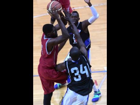 File
UWI Running Rebels player Ramal Carbon (left) drives to the hoop between Urban Knights' Tommy McDonald (background) and Arthur Martin in last season's opening National Basketball League game at the National Arena, which was played on Saturday, February 10, 2018.