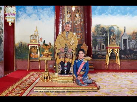 Thailand’s King Maha Vajiralongkorn sits on the throne beside his official consort, Sineenatra Wongvajirabhakdi, at the royal palace. 