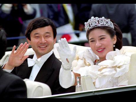 In this June 9, 1993, file photo, then Crown Prince Naruhito and Crown Princess Masako wave during their wedding parade in Tokyo. Japan is abuzz ahead of today’s ceremony marking Emperor Naruhito’s ascension to the Chrysanthemum Throne. 