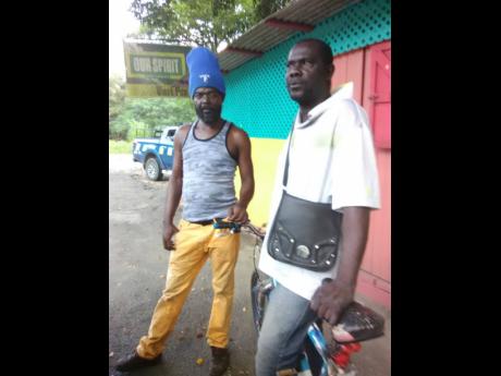 Carlton Williams (right) and Delroy Foster, two of the more than 40 fishermen affected by the Rio Cobre fish kill.