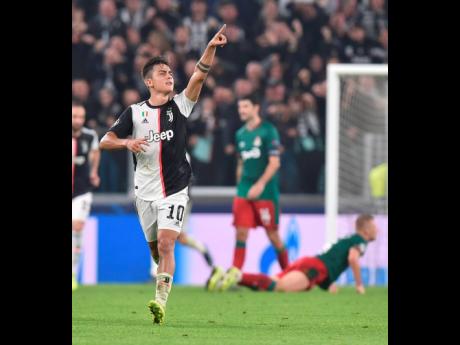 Juventus’ Paulo Dybala celebrates after scoring a goal during the UEFA Champions League Group D match against Lokomotiv Moscow at the Allianz Stadium in Turin, Italy, yesterday. Juventus won 2-1.  