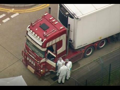 An aerial view as police forensic officers attend the scene after a truck was found to contain a large number of dead bodies, in Thurrock, South England, early Wednesday. 