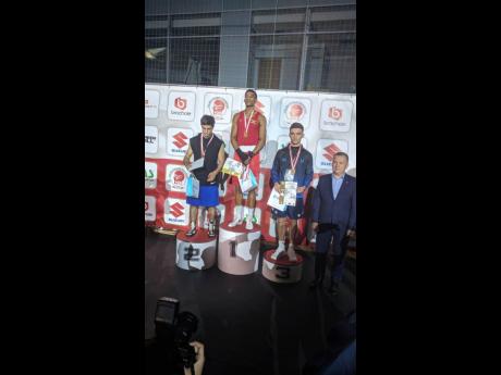 Jamaica’s Joshua Frazer (second left) stands atop the gold medal podium after beating Marat Gashimov (left) in the final of the Leszek Drogosz Memorial International Boxing Tournament in Kielce, Poland, yesterday.