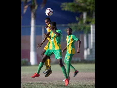 Charlie Smith High School’s Oshane Samuel (left) and Kingston High School’s Ronaldo Gordon compete for an aerial ball during an ISSA/Digicel Manning Cup game at the Breezy Castle field on Saturday, September 14, 2019.