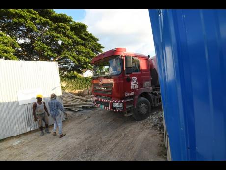 A Pre-Mix concrete mixer reversing into the property at 29A Dillsbury Avenue in St Andrew yesterday. The Supreme Court has ordered that construction activities be halted at the site.