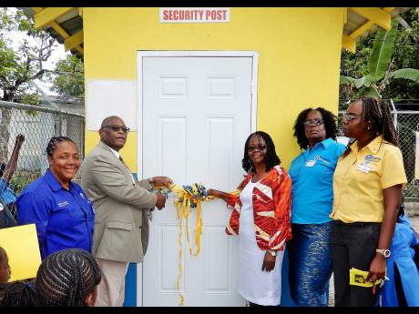 Kiwanis District Governor for Eastern Canada and the Caribbean, Melford Clarke (second left), and principal Sherron Minott of Breadnut Hill Primary School (third left), officially opening the security booth at the school, that was constructed by Kiwanis International Division 24. Sharing the occasion (from left), are Donna Coombs, lieutenant governor, Kiwanis Division 24, Beverley Wilson, president, Kiwanis Club Moneague, and Julian Gordon, president, Kiwanis Club Ocho Rios.