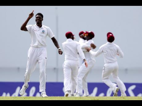 Windies bowler Alzarri Joseph (left) celebrates dismissing England’s captain, Joe Root, during day one of the second Test cricket match at the Sir Vivian Richards Stadium in North Sound, Antigua and Barbuda on Thursday, January 31, 2019.