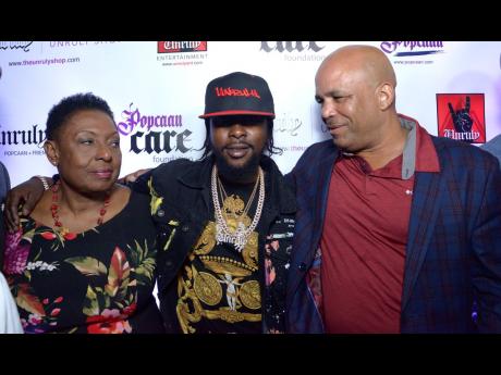 Minister of Culture, Gender, Entertainment and Sport Olivia ‘Babsy’ Grange, Popcaan and Member of Parliament for Western St Thomas James Robertson at the launch of Unruly Fest 2019 at Triple Century Sports Bar in New Kingston on Wednesday.