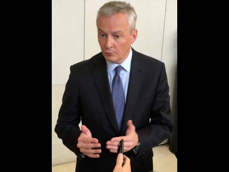 
French Finance Minister Bruno Le Maire answers reporters Thursday, October 31, in Paris. The boards of Fiat Chrysler and PSA Peugeot announced on Thursday fast-moving plans to merge the two companies.