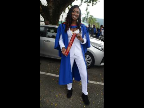 The University of the West Indies graduate Shaneilia Ellis beams with pride after collecting her degree last Saturday. 