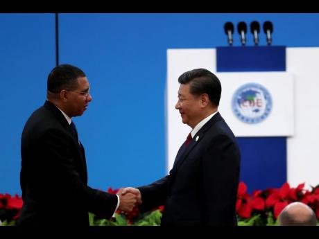 Jamaican Prime Minister Andrew Holness (left) greets Chinese President Xi Jinping at the opening ceremony of the China International Import Expo in Shanghai on Tuesday, November 5.