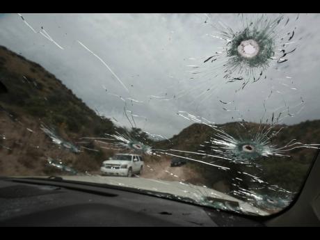 Bullet-riddled vehicles that members of the extended LeBaron family were traveling in sit parked on a dirt road near Bavispe, at the Sonora-Chihuahua state border, Mexico, Wednesday, Nov. 6, 2019. Three women and six of their children, related to the extended LeBaron family, were gunned down in an attack while traveling here Monday. 