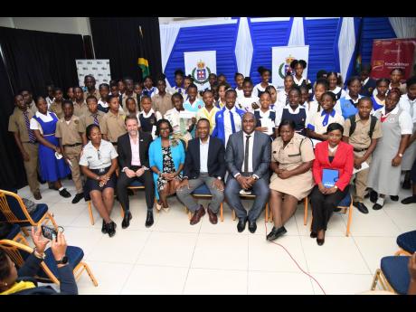Scholarship awardees with (seated from left) Sargeant Gillian Faulknor; Chris Hind, CEO, JN General Insurance; Onyka Barrett Scott, general manager, JN Foundation; Wayne Wray, chairman,  Area  Four Police Civic Committee; Senior Superintendent Steve McGregor, operations officer for Police Area Four; Superintendent Tomielee Chambers, police Area Four Community Safety and Security Division; and Andrea Whyte, markets manager, KPMG Jamaica. 