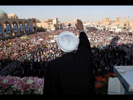 President Hassan Rouhani waves to the crowd in a public gathering at the city of Yazd, some 410 miles southeast of the capital Tehran, Iran, yesterday. 