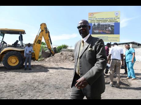 Minister of Local Government and Community Development Desmond McKenzie walks away after the groundbreaking ceremony for the construction of an adult transitional facility on King Street on Monday. The facility, which will be a one-of-a-kind in Jamaica, was the brainchild of the former mayor and will be built on property owned by the Kingston and St Andrew Municipal Corporation.