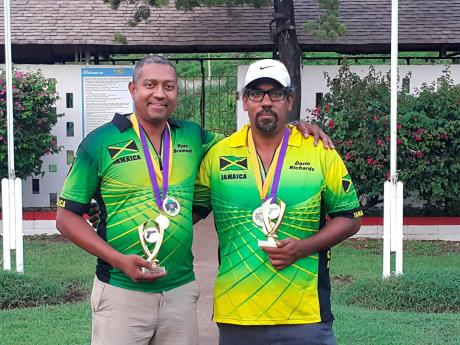 Ryan Bramwell (left) and Darrin Richards pose with their trophies after emerging as division winners at the hotly contested Liguanea Cup Pistol Shooting Competition, which was held at the Jamaica Rifle Association’s headquarters in Kingston over the weekend. Bramwell scored 937.2399 points to win the Standard division, while Richards topped the Production division with 913.6657 points. Missing is Kevin Cheung, who won the Open division with 925.0188 points.