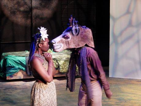 Titania (Marci-Lee Smith), Queen of the Fairies, is under a magic spell as she tells the donkey-headed Bottom (Javian Kiffin) that she loves him. 