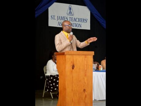 JTA President Owen Speid addresses the half-yearly meeting at the St John’s Methodist Church in Montego Bay on Friday. 