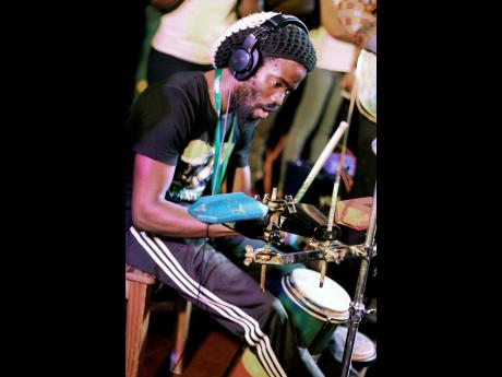 Percussionist Hector Lewis shows his versatility on the multi-percussion rack and hand drums.