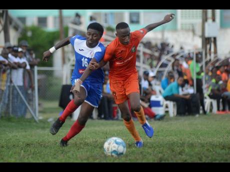 Tivoli Gardens' Trayvon Reid (right) challenges Roberto Johnson of Portmore United in a chase for the ball during their Red Stripe Premier League match at the Edward Seaga Complex on Sunday afternoon.