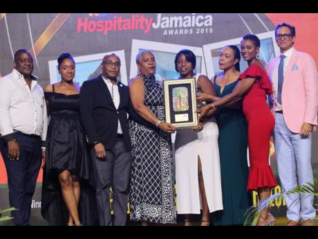 Tai Flora’s Jessica Riley (second right) presents the Most Eco/Sustainable Award to Kyle Mais (right), general manager, Jamaica Inn, and his team.