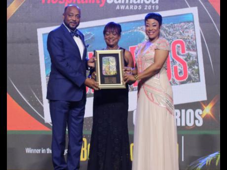  Mayor of St Ann's Bay Michael Belnavis and Vana Taylor (centre), president of the St Ann Chamber of Commerce, accept the Best Resort Town award from Copa Airlines' Nicole Cunningham.