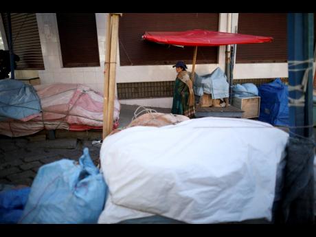 A woman walks by a closed market in La Paz, Bolivia, yesterday. 