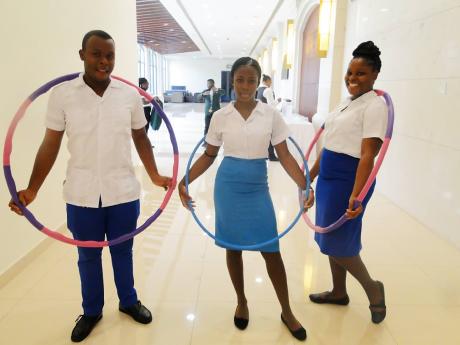 From left: Kareem Senior, Abigail Parke and Christina Campbell of the HEART College of Hospitality Services in Runaway Bay, St Ann, posing after a hula-hoop challenge.