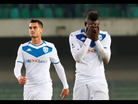 Brescia’s Mario Balotelli (right) holds his head in his hands at the end of an Italian Serie A match against Hellas Verona, where he was racially abused by their fans, at the Bentegodi Stadium in Verona, Italy, on Sunday, November 3.