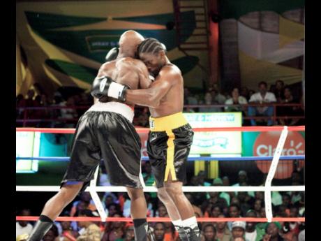 Kevin ‘Bus Boy’ Hylton (right) up against Ian ‘Hagler’ Smith in a Wray and Nephew Contender match at the Chinese Benevolent Association Auditorium in St Andrew on Wednesday, May 2, 2012. 