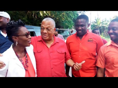 PNP President Dr Peter Phillips (second left) discusses party matters with Andrea Dehaney, councillor for the Sandy Bay division, during a tour on Friday, November 22, 2019. Looking on are Wavell Hinds (second left), prospective candidate for Hanover Eastern, and Dwayne Vaz, chairman of Region Six. 