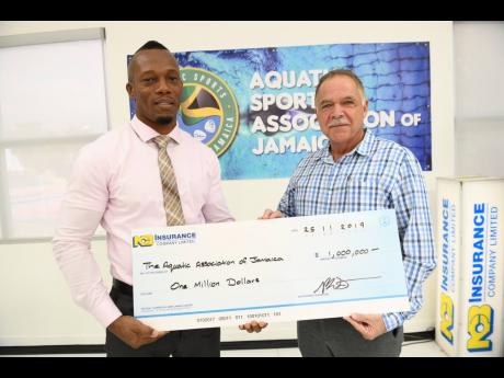 Calneth Gray (left), Acting Regional Manager, National Commercial Bank Insurance Company, hands over a cheque to Martin Lyn, President of the Aquatic Sports Association of Jamaica, at the launch of the 2019 NCB Insurance Company Preparatory/ Primary Schools Swim meet, which took place on Monday.