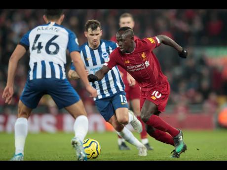 
Liverpool’s Sadio Mane (right) fights for the ball against Brighton’s Steven Alzate (left) and Pascal Gross during the English Premier League match between Liverpool and Brighton at Anfield Stadium, Liverpool, England, yesterday. Liverpool won 2-1.