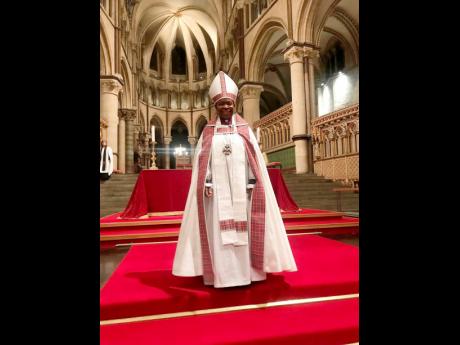 Newly enthroned Bishop Hudson-Wilkin, resplendent in white vestment trimmed with bandana, at Canterbury Cathedral during her installation yesterday.