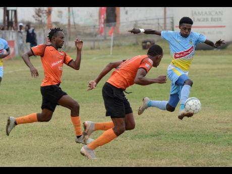 Waterhouse's Denardo Thomas (right) dribbles away from Tivoli Gardens' Tevin Garnett (left) and Kevin Seivwright during their Red Stripe Premeir League match at the Edward Seaga Complex on Sunday, March 17, 2019.
