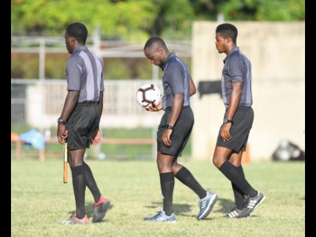 The Red Stripe Premier League game between Portmore United and Dunbeholden was delayed for 20 minutes because only three of the four assigned officials, pictured here, arrived on time at the Spanish Town Prison Oval in St Catherine yesterday.