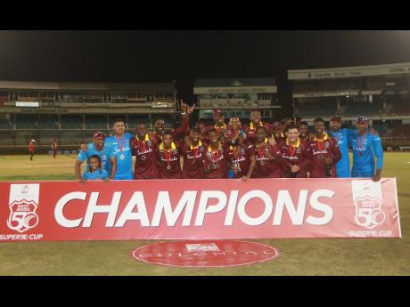 Members of the Windies Emerging Players team celebrate with he winners’ trophy after capturing the Cricket West Indies Colonial Medical Insurance Super50 Cup championship at the Queen’s Park Oval in St Clair, Trinidad and Tobago, on Sunday. 