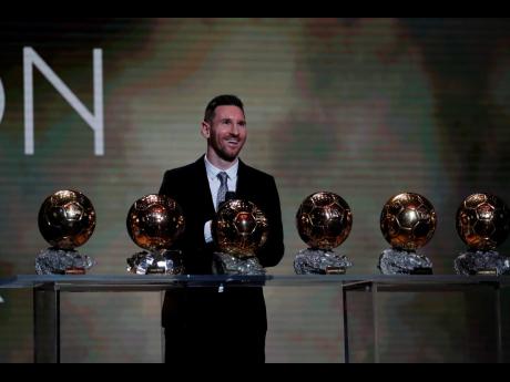 Barcelona footballer Lionel Messi poses with his six Ballon d’Or trophies won throughout his career during the Ballon d’Or award ceremony in Paris, France yesterday.