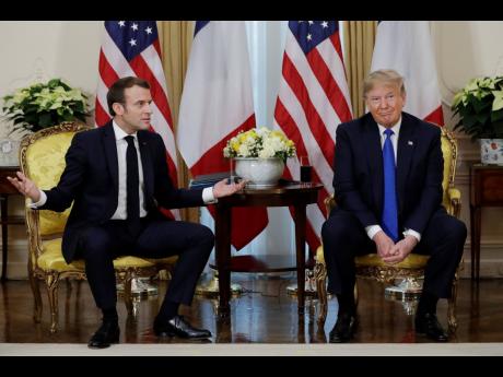 President Donald Trump meets French President Emmanuel Macron at Winfield House in London yesterday.