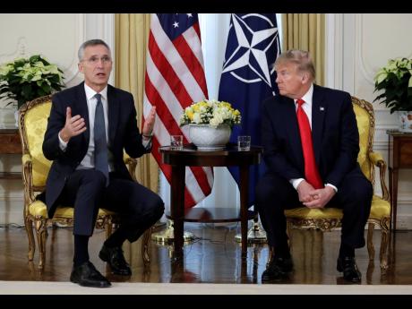 US President Donald Trump (right) meets NATO Secretary General Jens Stoltenberg at Winfield House in London yesterday.  