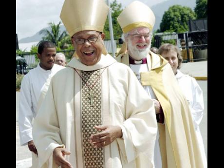 The Rt Rev Alfred Reid, then Bishop of Jamaica and the Cayman Islands, leads then  Archbishop of Canterbury the Most Rev Dr Rowan Williams towards the National Arena for a special church service in May 2009. 