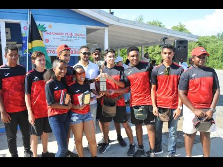 Members of the Campion College team pose with their trophy after taking top honours at the ATL Automotive Inter Schools Sporting Clay Challenge at the Jamaica Skeet Club in St Catherine on Sunday. Presenting the trophy is David Henriquez (sixth left), head of business, Porsche, ATL.