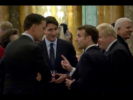 In this grab taken from video on Tuesday, Canadian Prime Minister Justin Trudeau (third left) is seen standing in a huddle with French President Emmanuel Macron, British Prime Minister Boris Johnson, Dutch Prime Minister Mark Rutte and Britain’s Princess Anne (partly hidden). 
