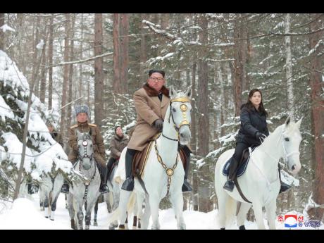 North Korean leader Kim Jong Un (centre), with his wife Ri Sol Ju (right), riding on white horse during his visit to Mount Paektu, North Korea. 
