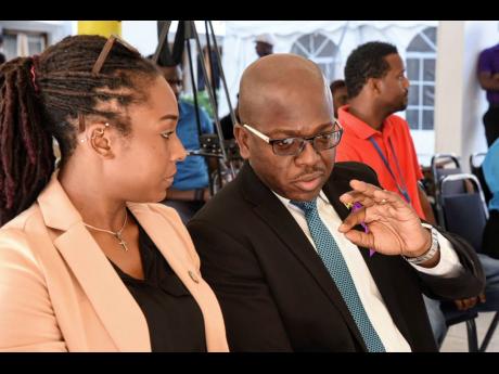 Minister without Portfolio in the Ministry of Economic Growth and Job Creation, Senator  Pearnel Charles Jr (right), in discussion with Director and Founder of the Jamaica Climate Change Youth Council, Eleanor Terrelonge, during the University of the West Indies (UWI) Mona Guild Climate Action Conference 2019 Project Plan, held at the university’s St Andrew campus, on November  29. The forum was hosted by the UWI Mona Guild External Affairs Committee. 